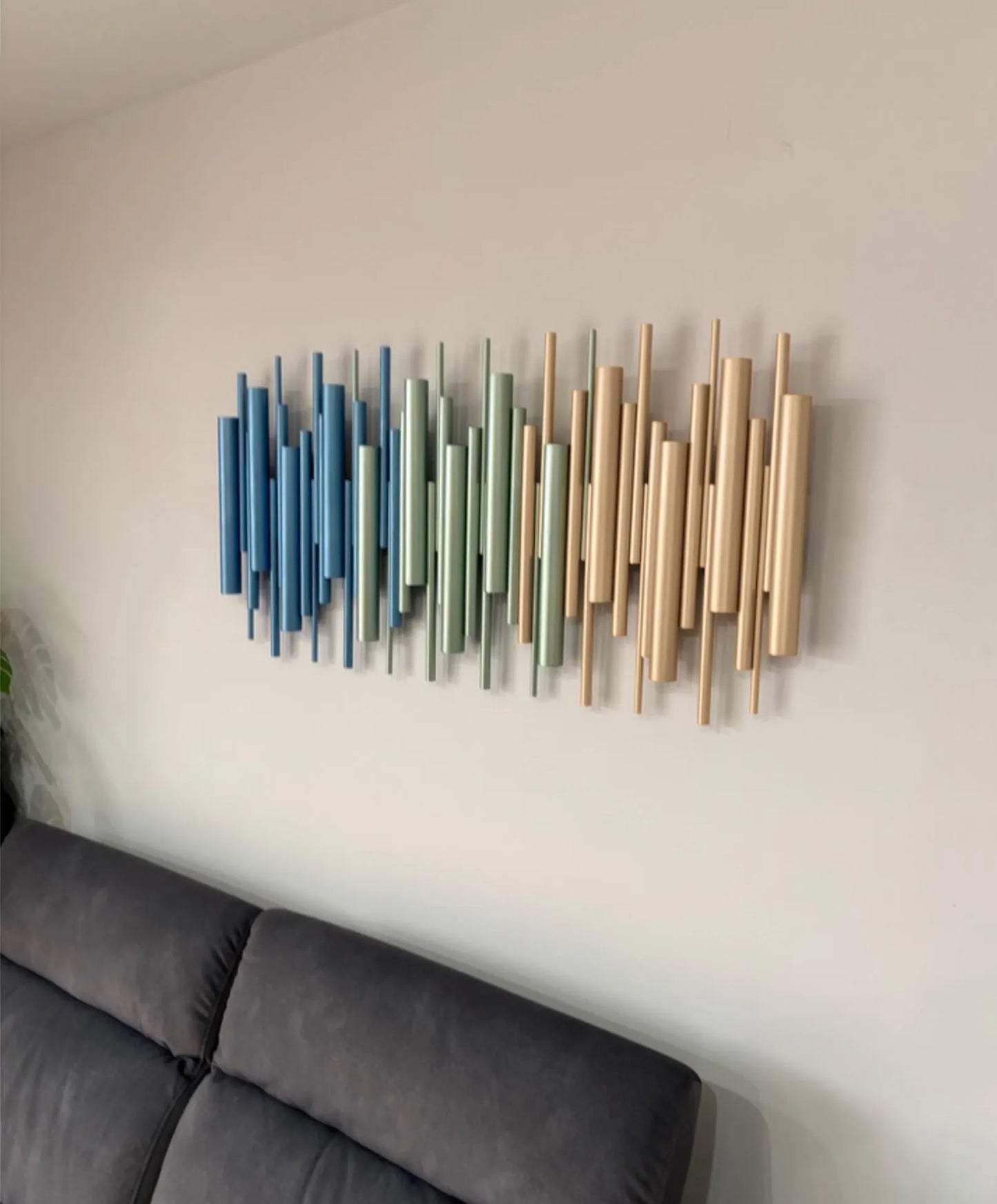 Azure metallic blue, sage and champagne gold wood wall art sculpture above grey sofa – Berties Blocks