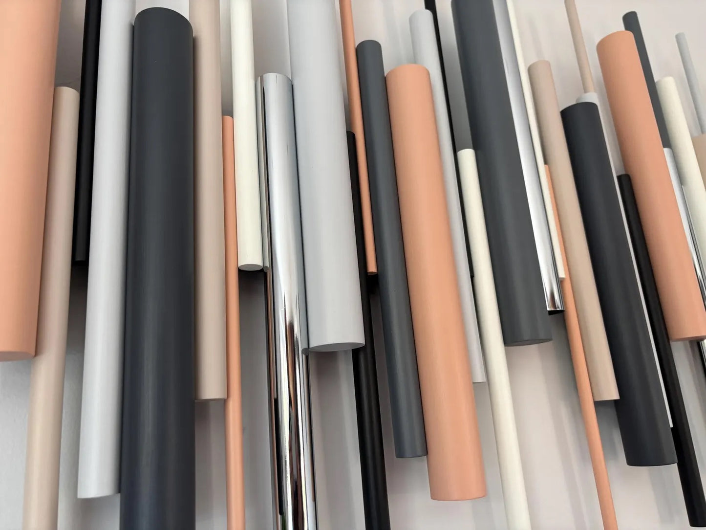 Cinder wall art close up showing layered black and neutral tone wooden dowels – Berties Blocks