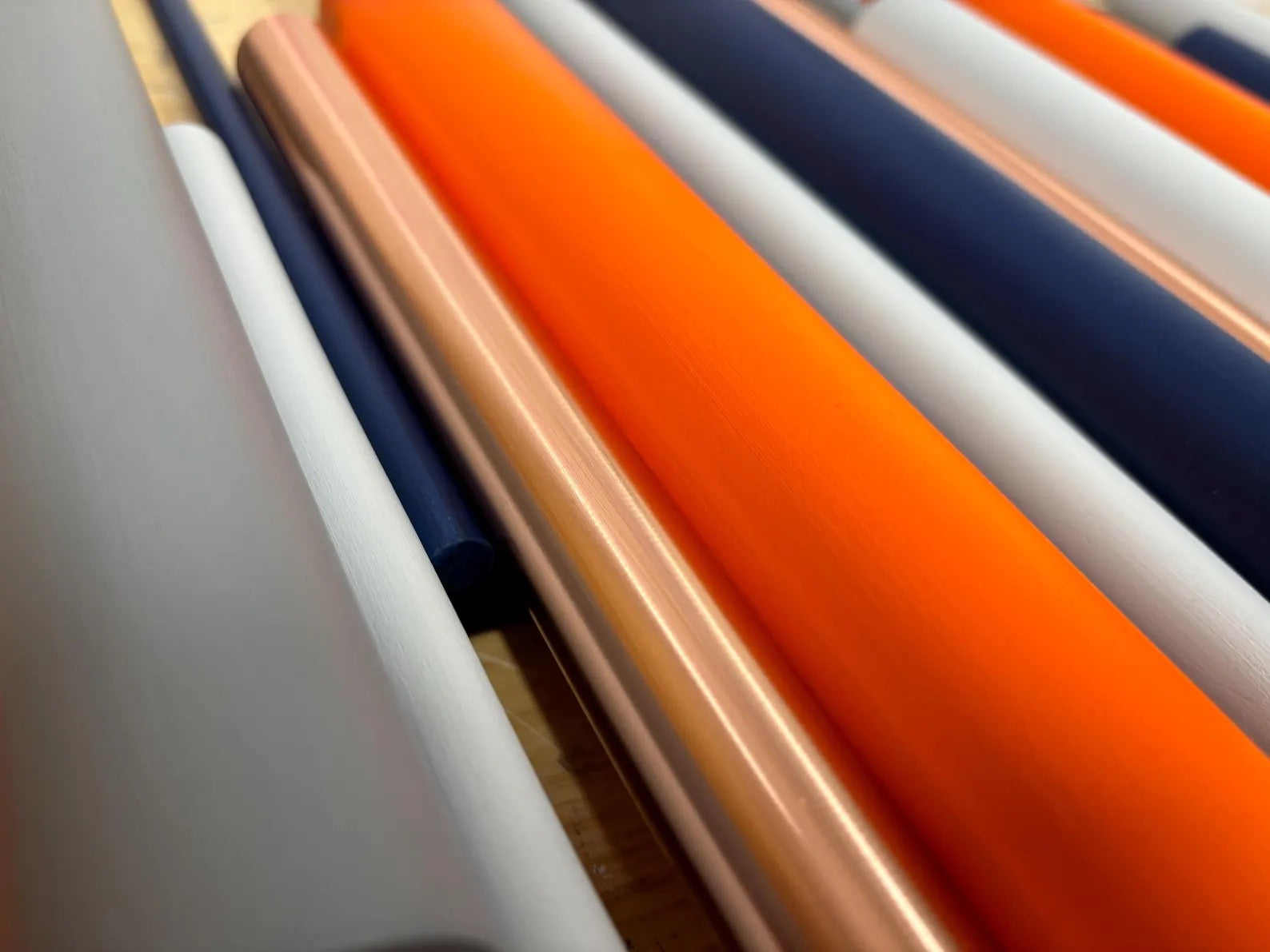Solstice wall art close up detail showing layered orange and blue dowels with polished copper accents – Berties Blocks